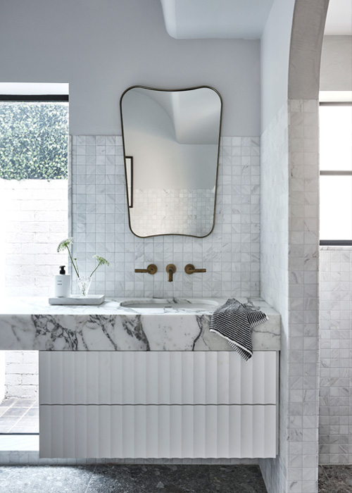 fluted vanity with feature marble top and brass details at Woollahra bathroom