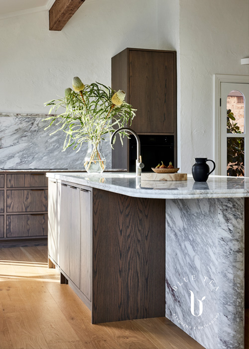 Curved marble and timber island detail and Woollahra