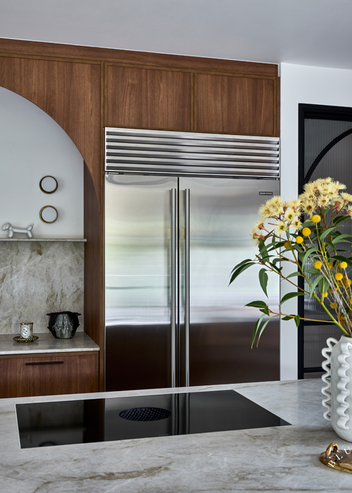 Sub Zero fridge next to curved timber joinery at our Mosman kitchen.