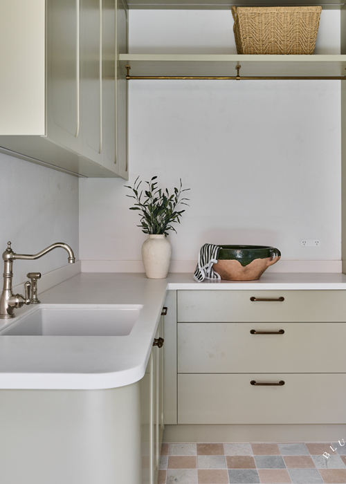 A soft green laundry with marble chequered floors at Vaucluse.