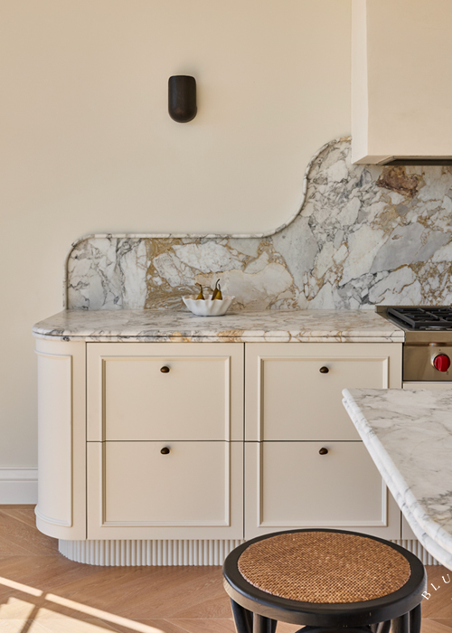 Detailed joinery and marble featuring fluted kickboards and wall sconces at our Vaucluse kitchen.